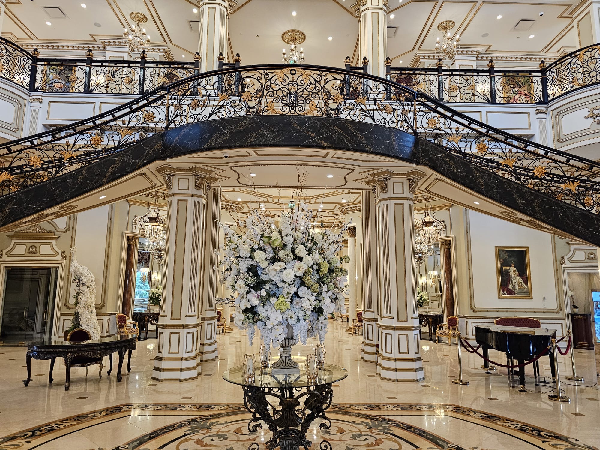 Grand wedding venue with ornate staircase and florals